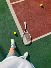 A person standing on a tennis court holding a racquet