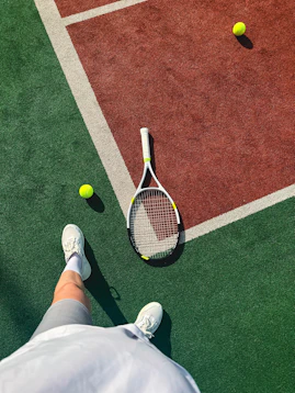 A person standing on a tennis court holding a racquet