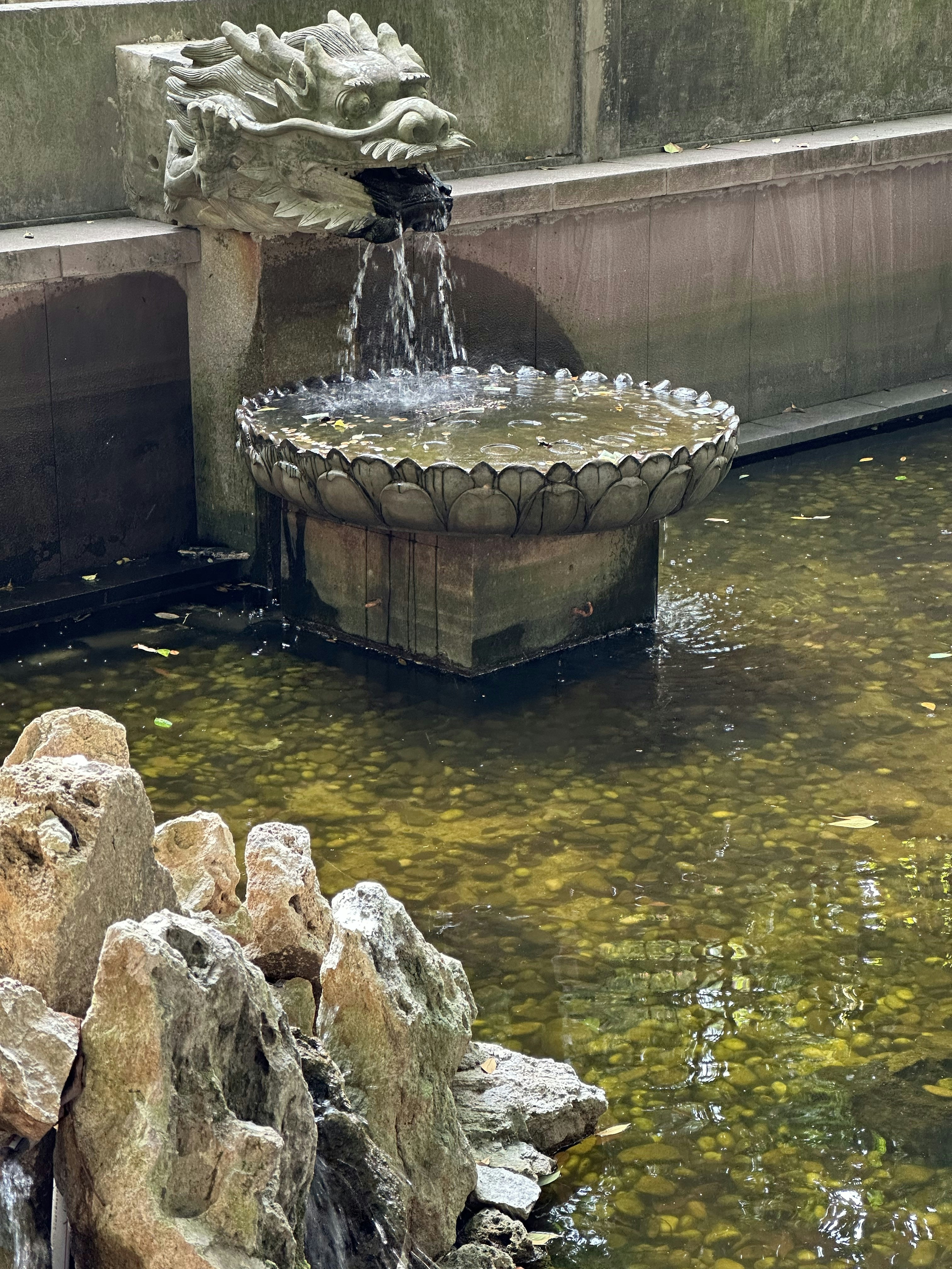 A fountain with a bird sitting on top of it