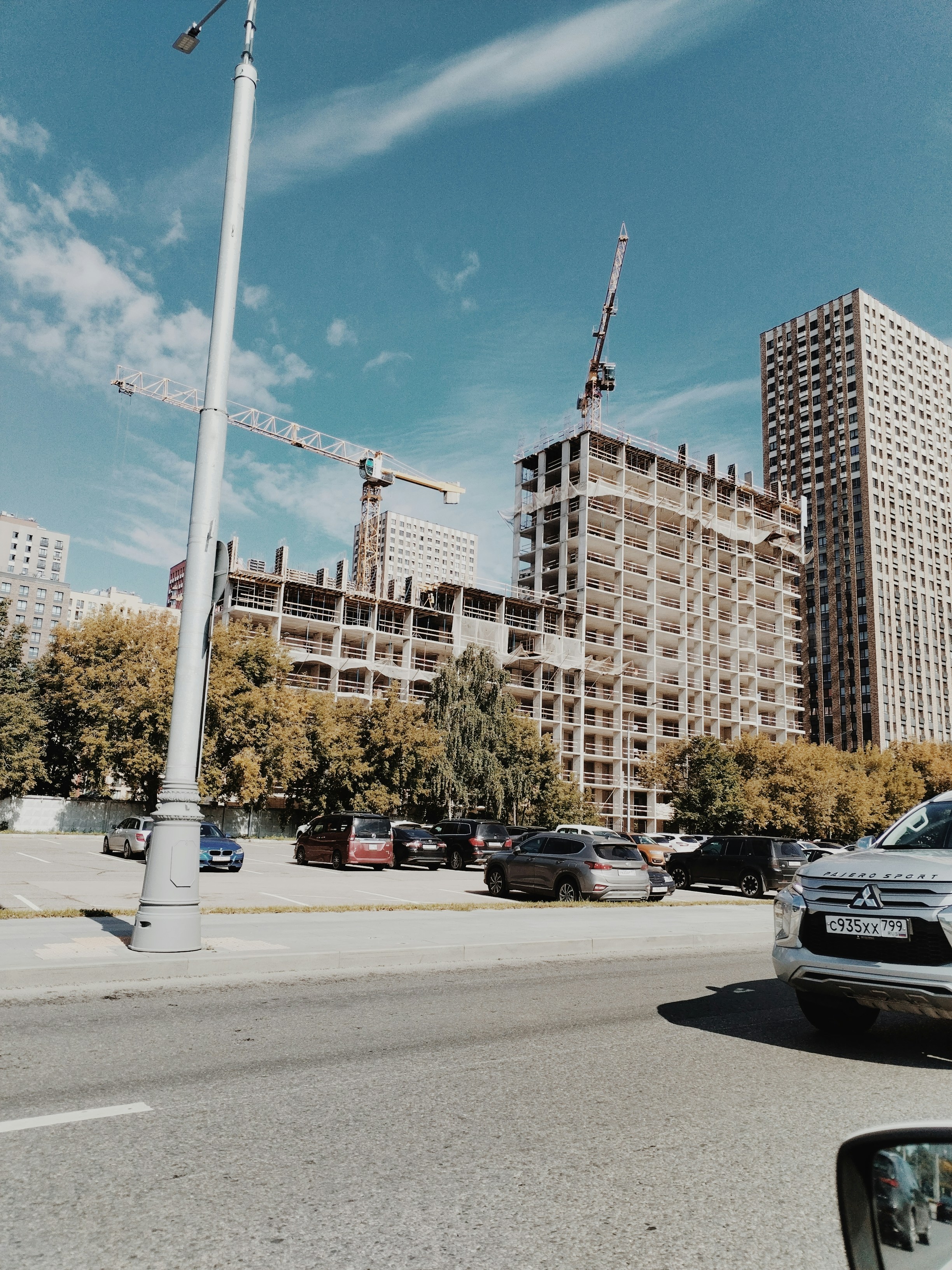 A car driving down a street next to tall buildings