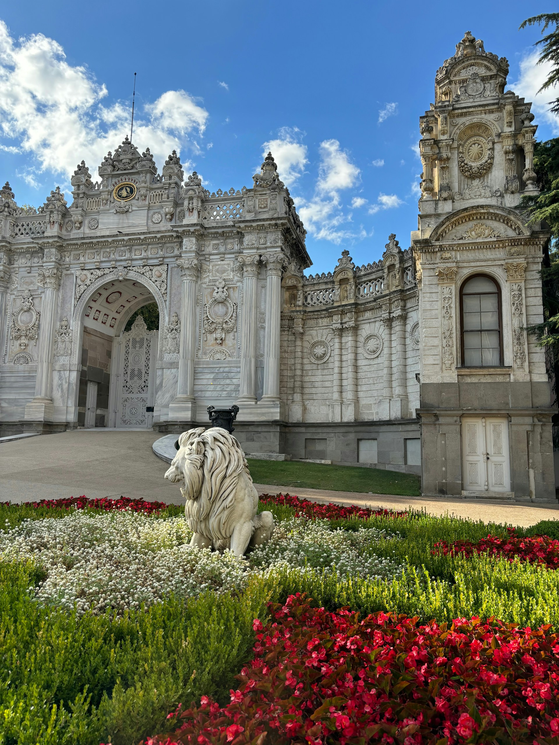 A large white building with a white lion statue in front of it