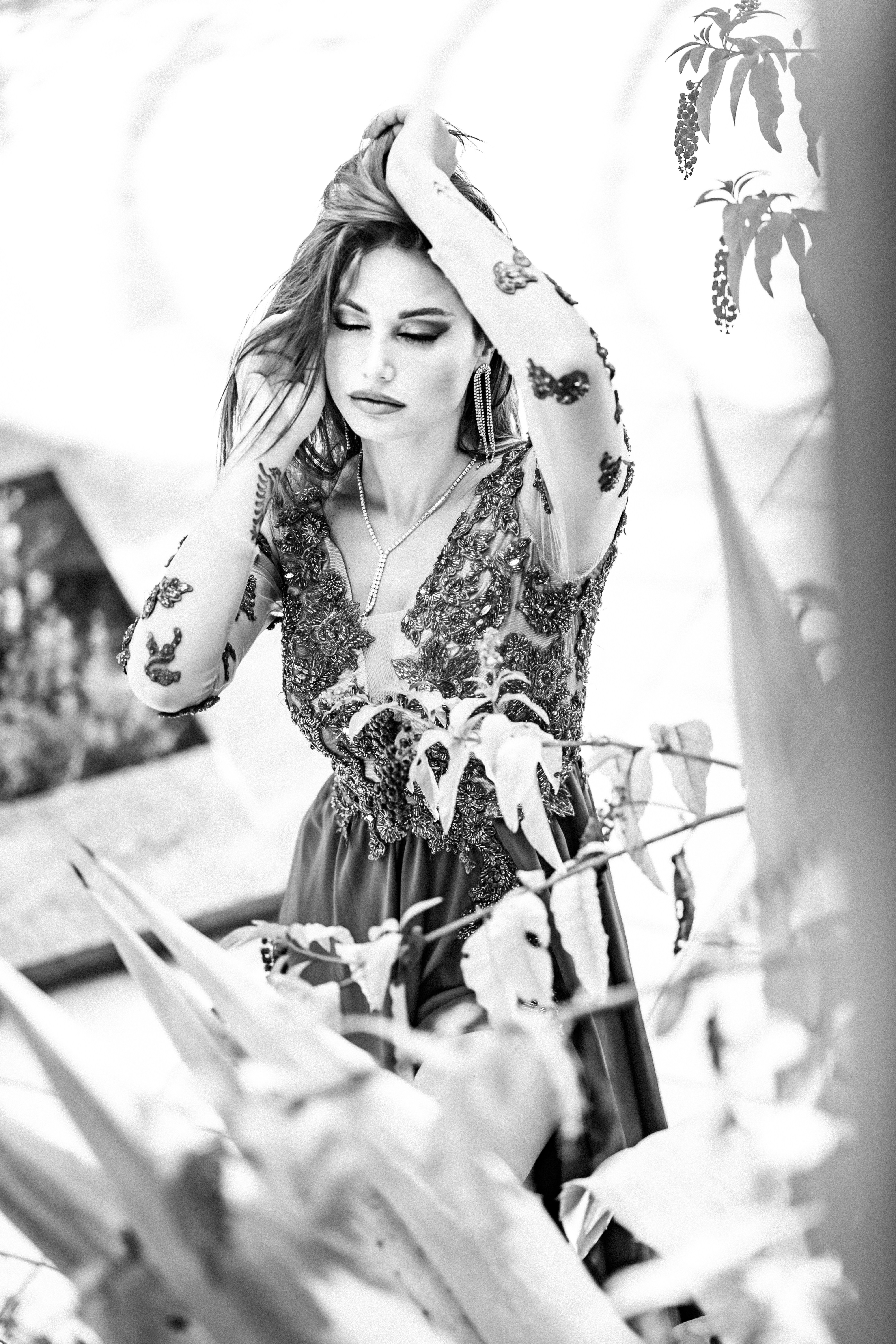 A woman in a dress is holding her head