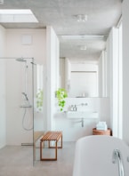 A bathroom with a tub, sink, and shower