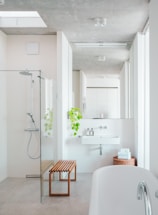 A bathroom with a tub, sink, and shower