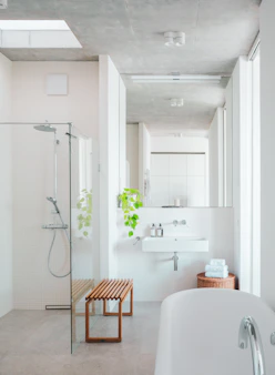 A bathroom with a tub, sink, and shower