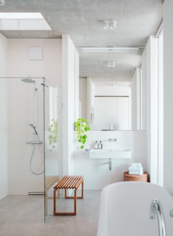 A bathroom with a tub, sink, and shower