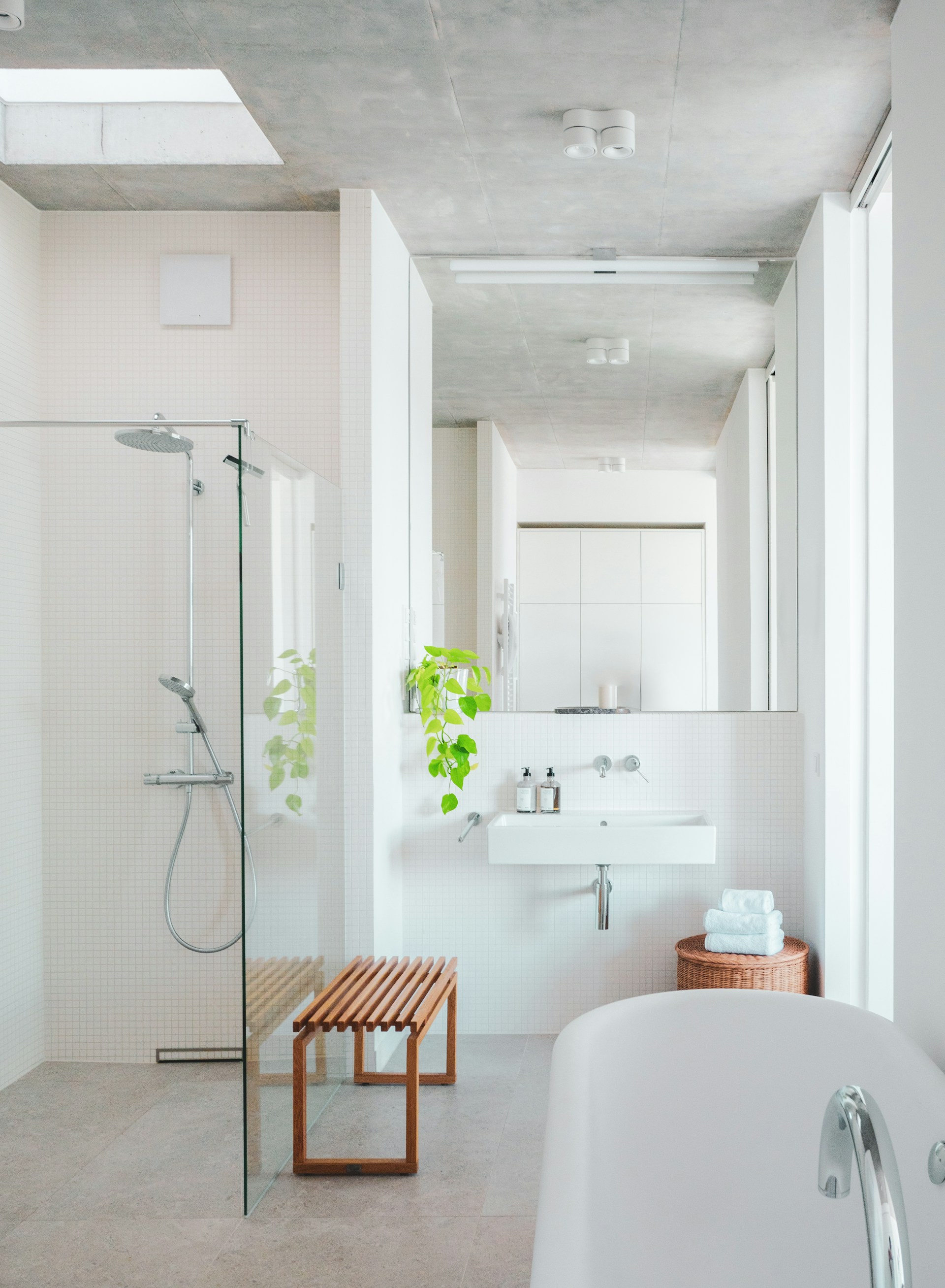 A bathroom with a tub, sink, and shower