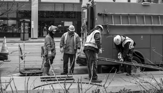 A black and white photo of men working on a street
