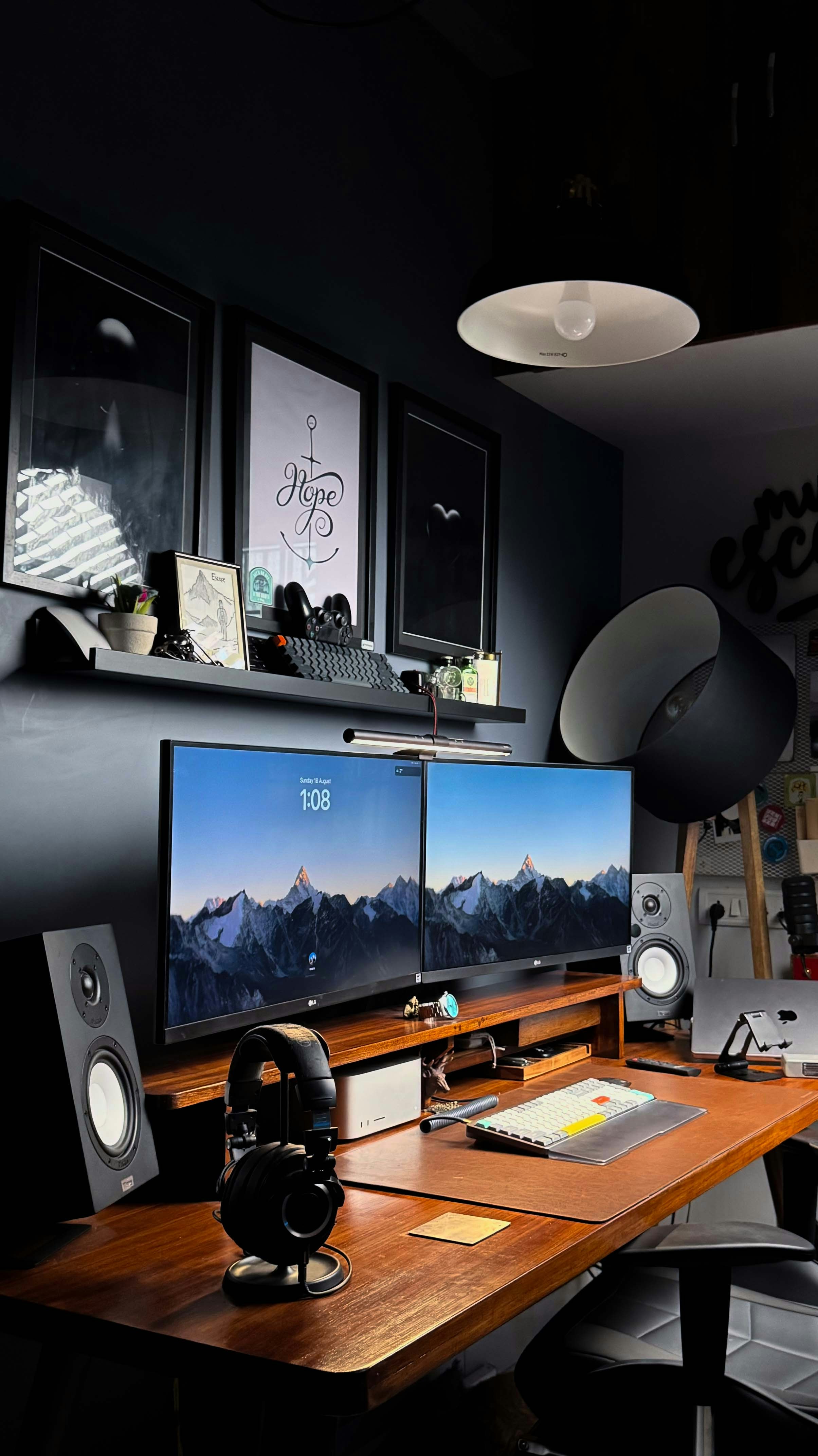 A computer desk with two monitors and speakers