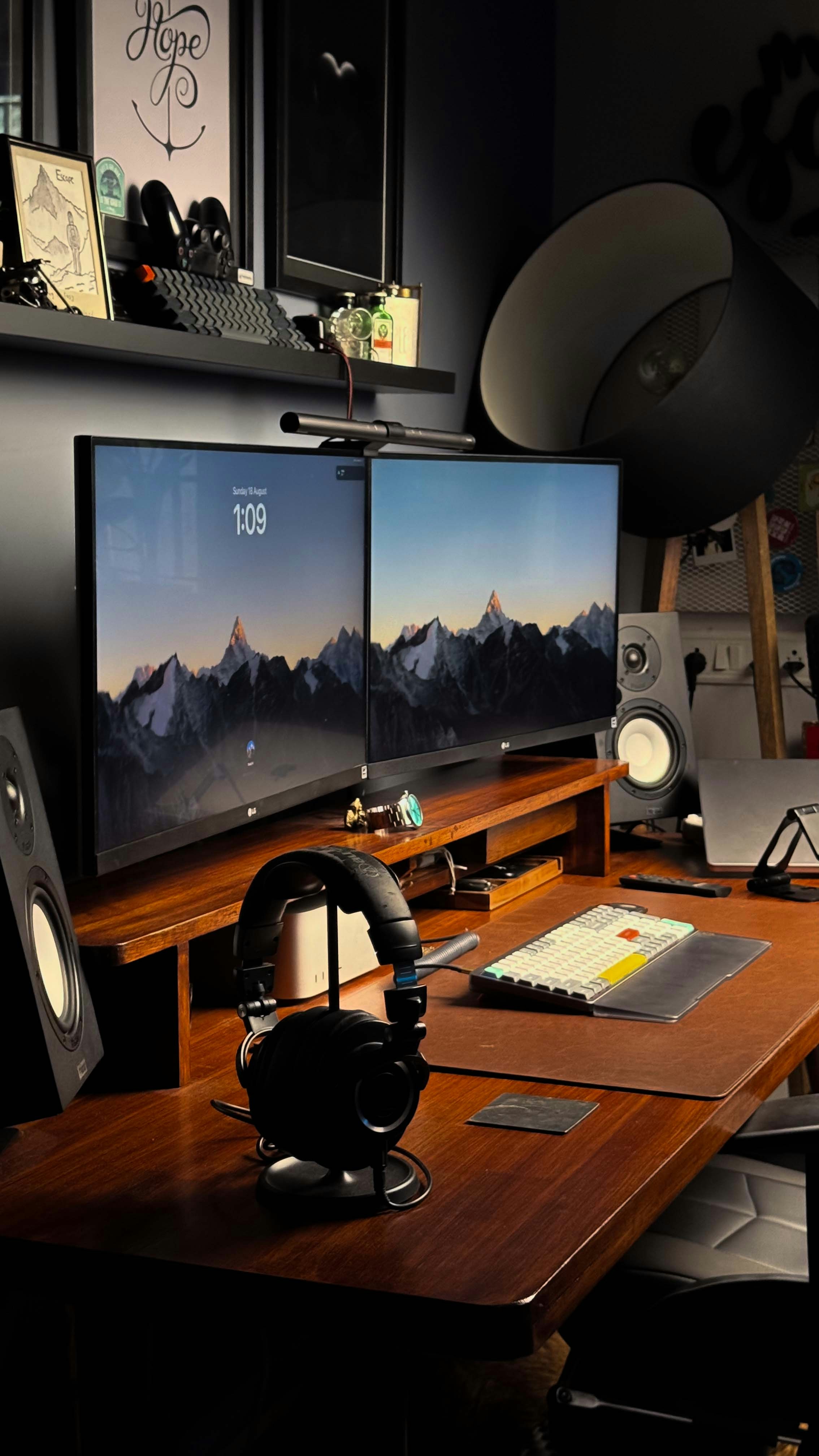 A desk with a computer monitor and speakers