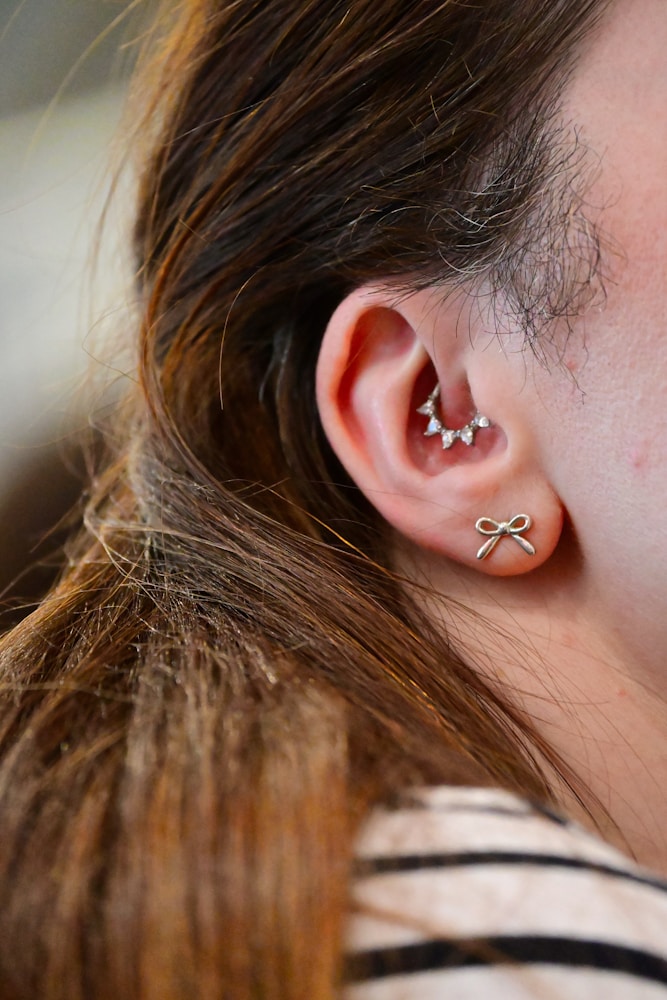 Close-up of an ear with healed helix and lobe piercings