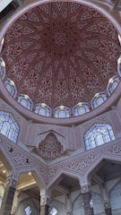 The ceiling of a large building with many windows