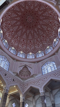 The ceiling of a large building with many windows