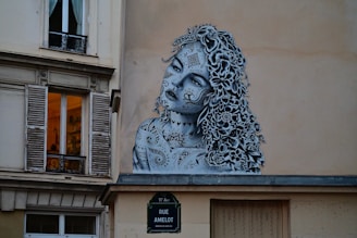 A painting of a woman on the side of a building