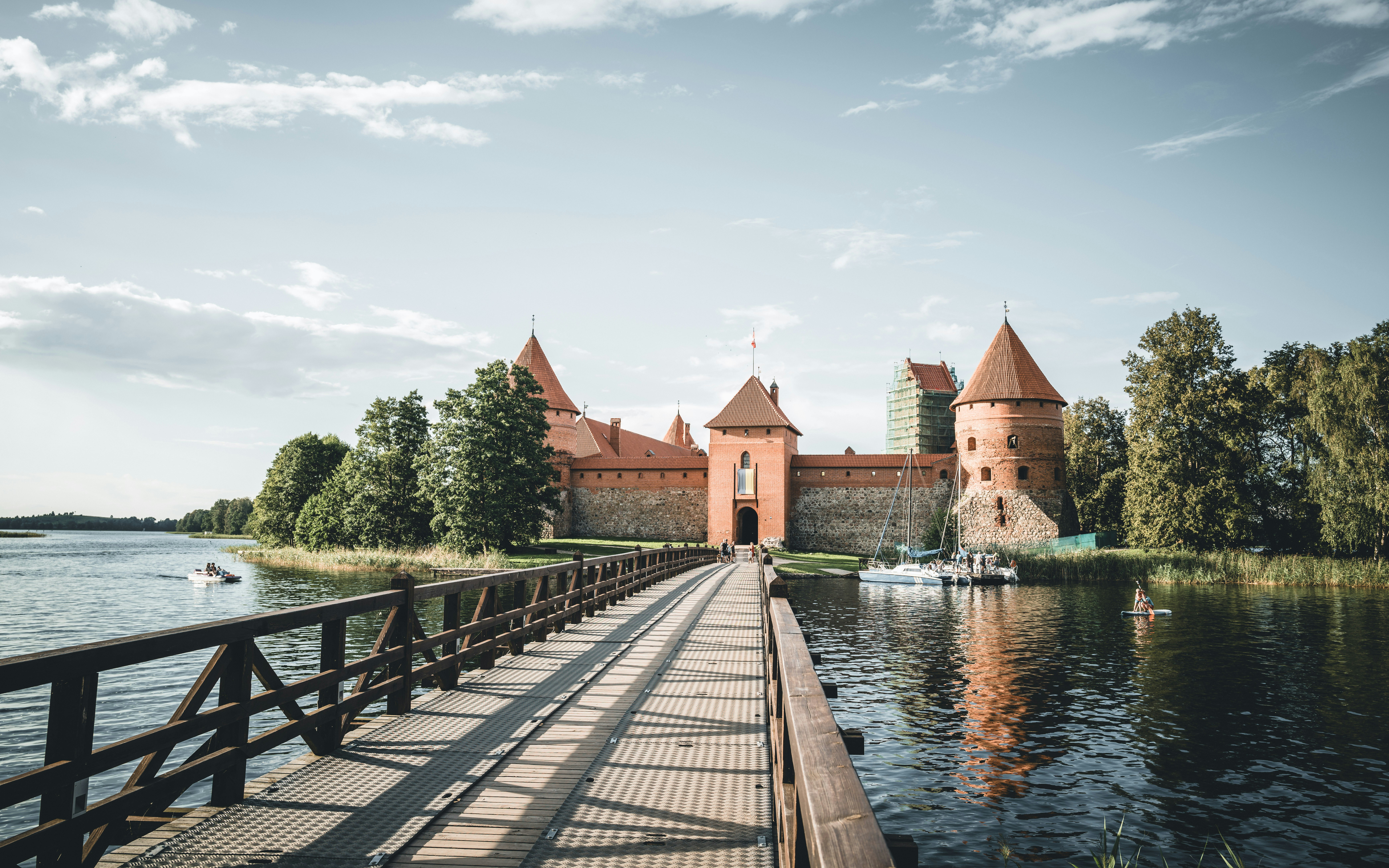 A bridge over a body of water with a castle in the background