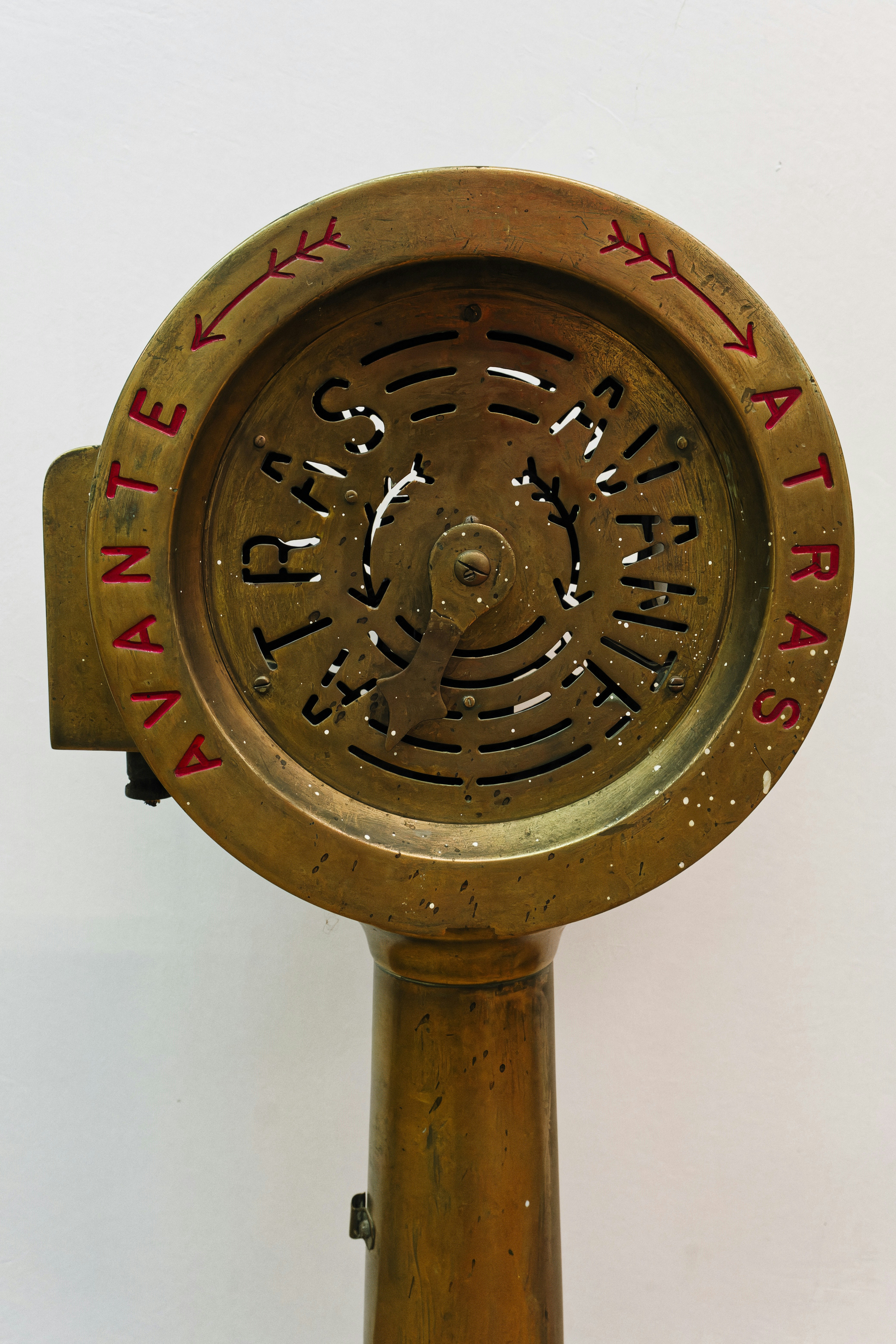 An antique clock with the time on it's face