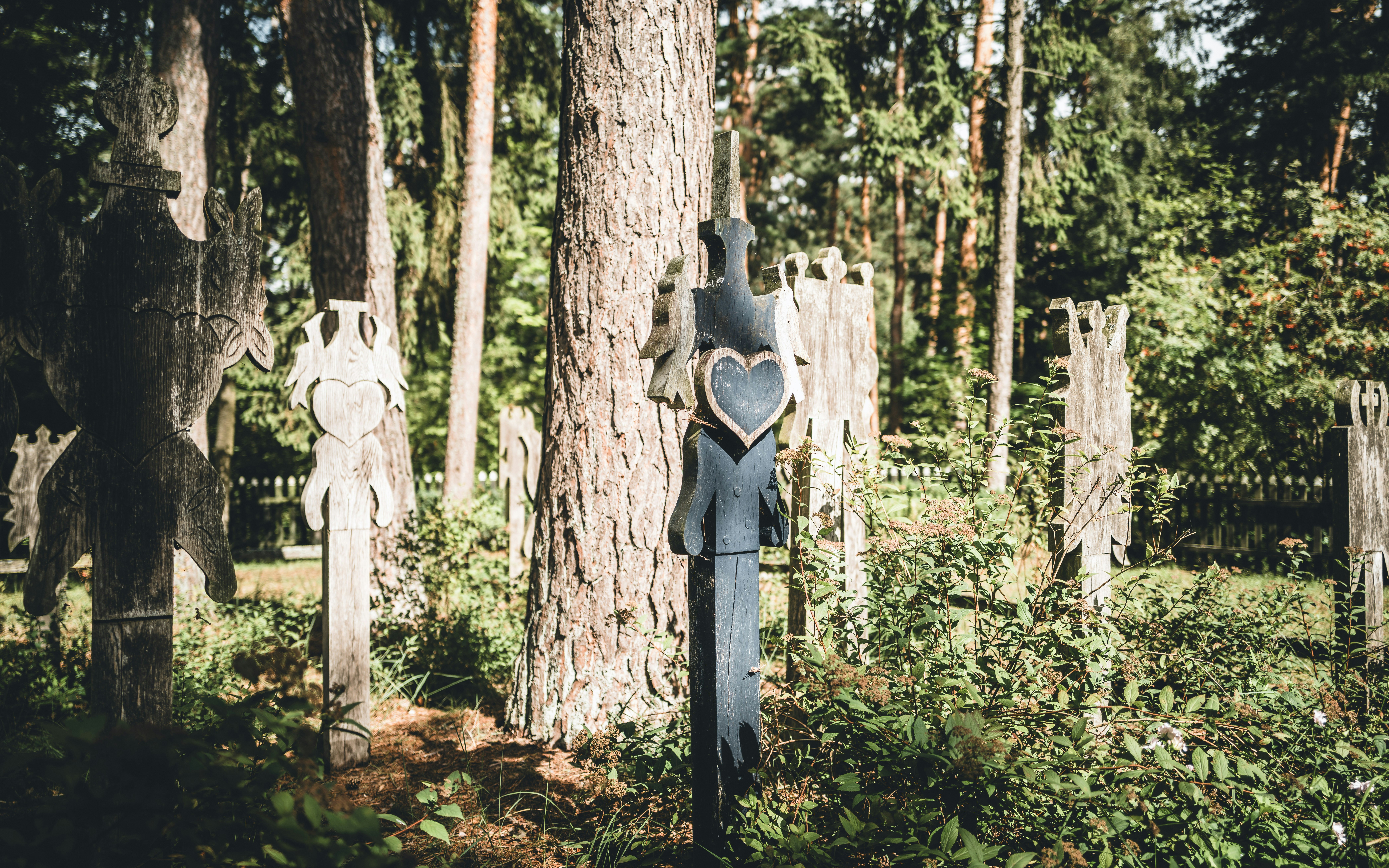 A wooden carving of a man in a forest