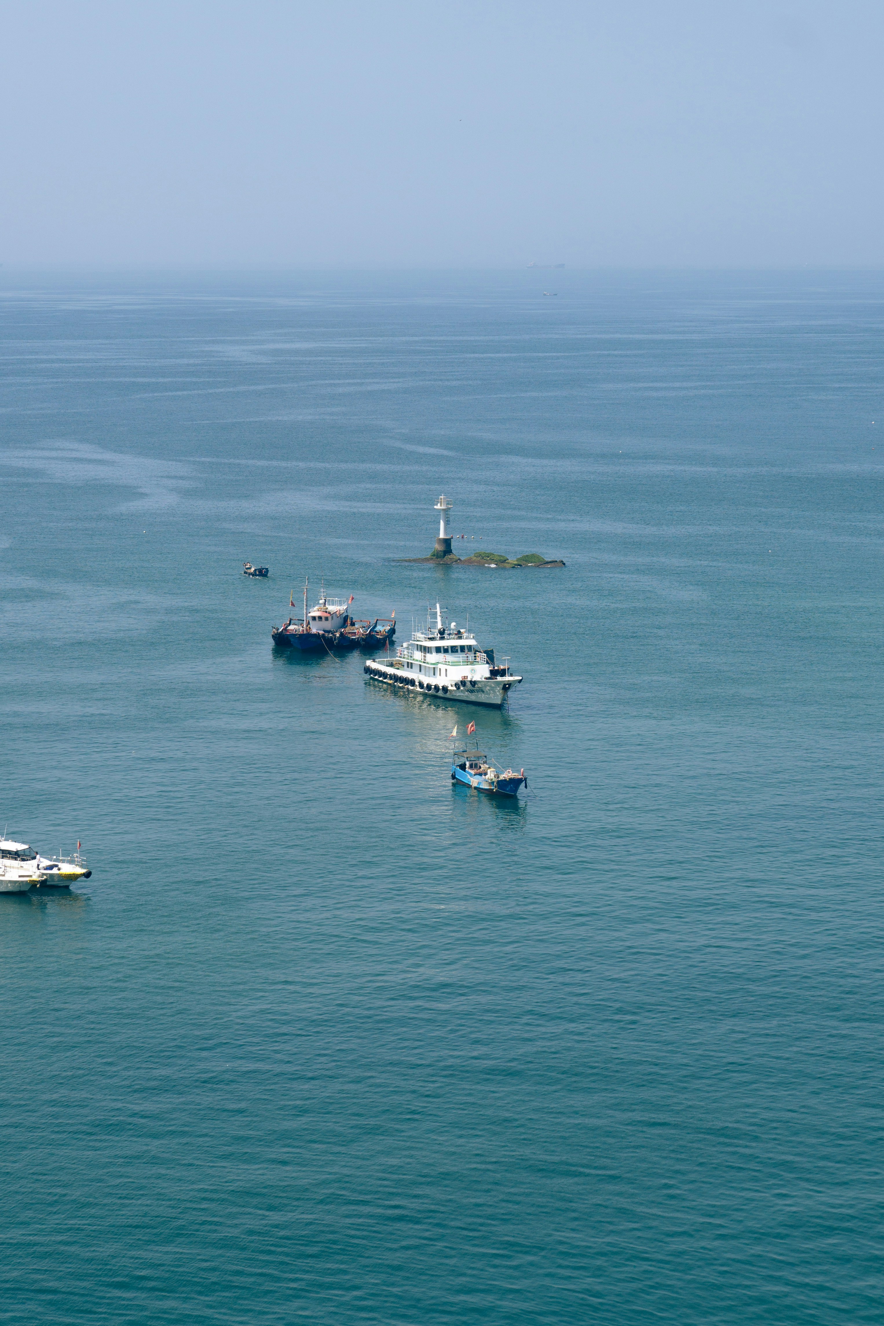 A group of boats floating on top of a large body of water