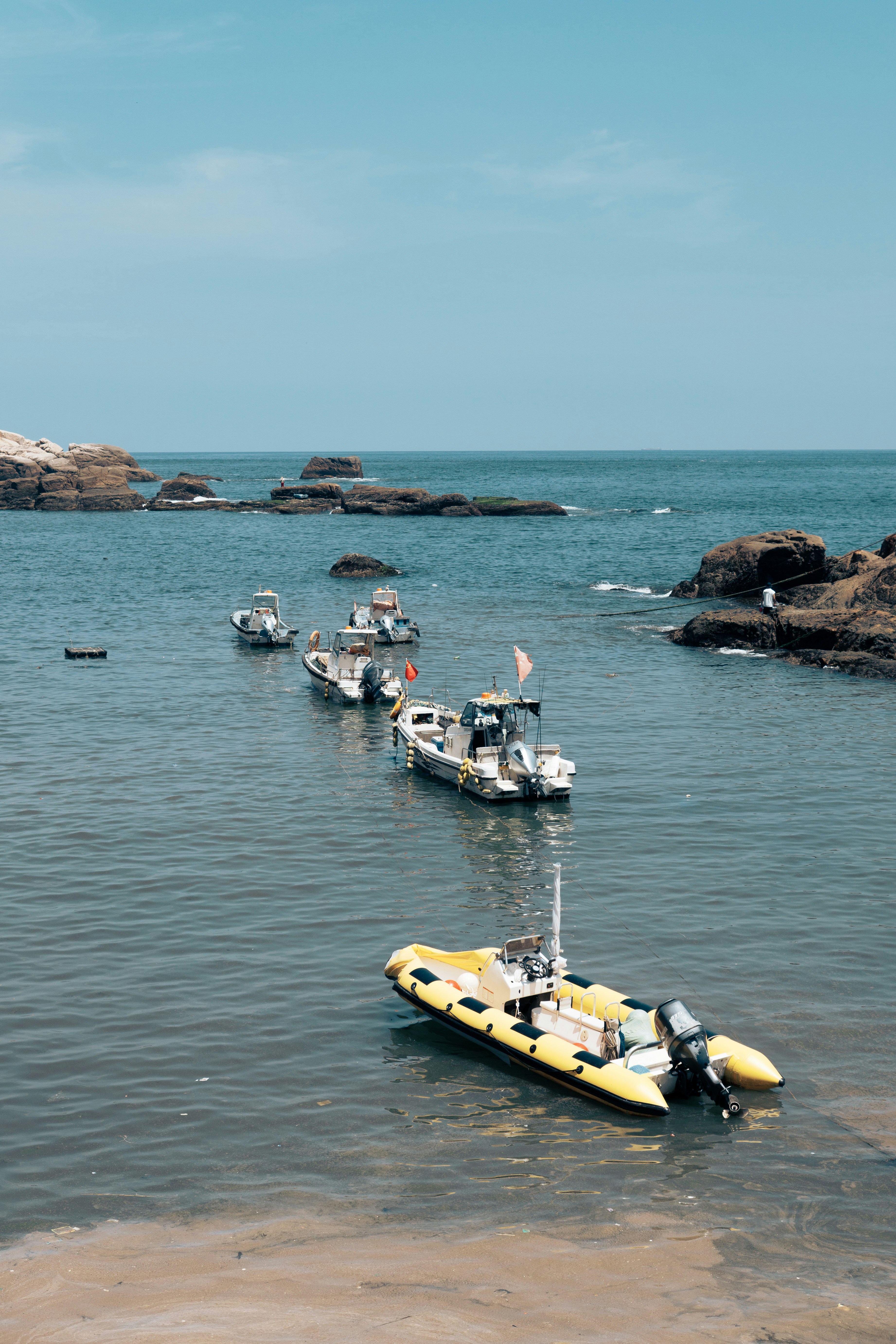 A group of boats floating on top of a body of water