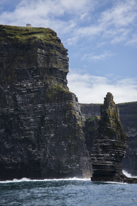 A large rock formation in the middle of a body of water