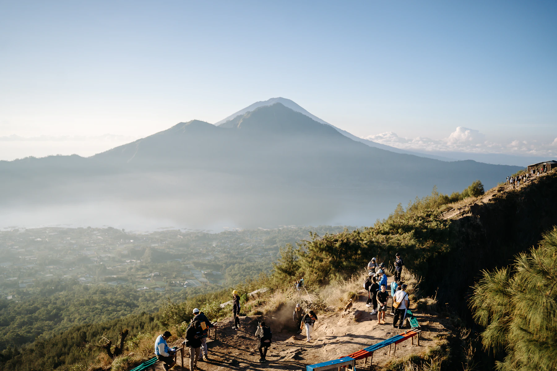 Outdoor Activities in Bali: Choose by Location, Conditions and Ability image 1: Hikers follow the exposed Mount Batur trail above a lake and layered volcanic ridges.
