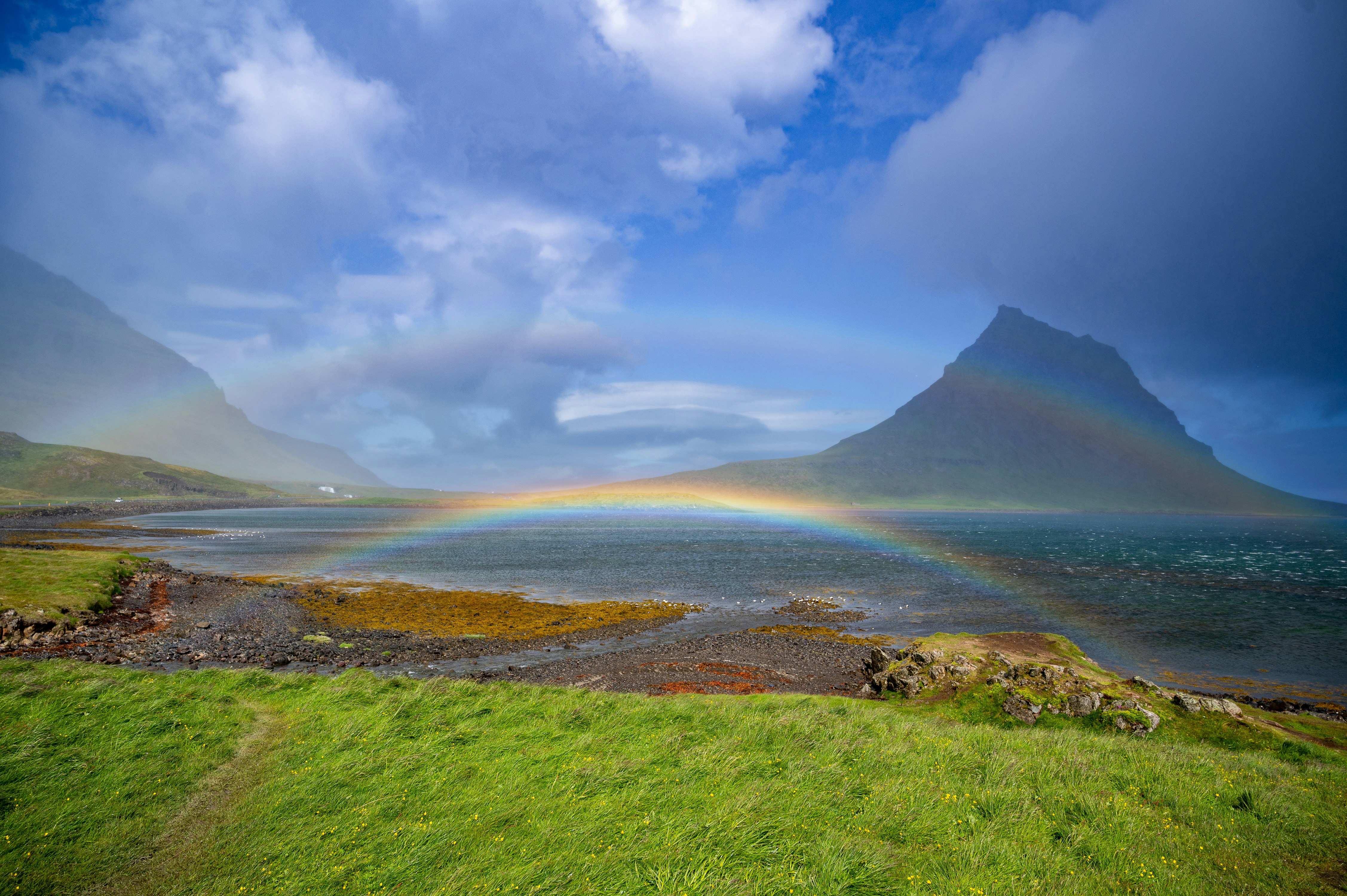 A rainbow in the sky over a green field