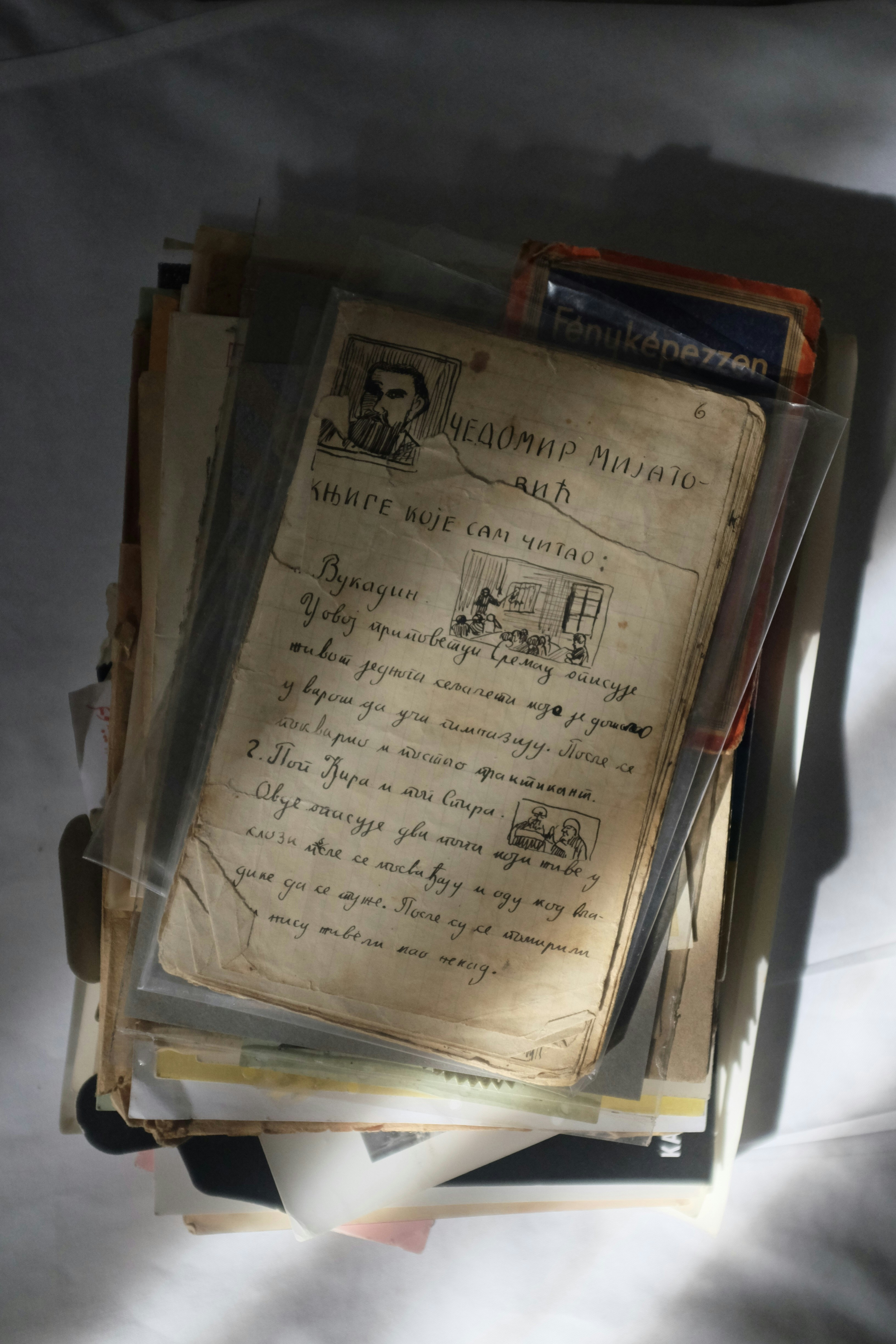 A stack of papers sitting on top of a bed