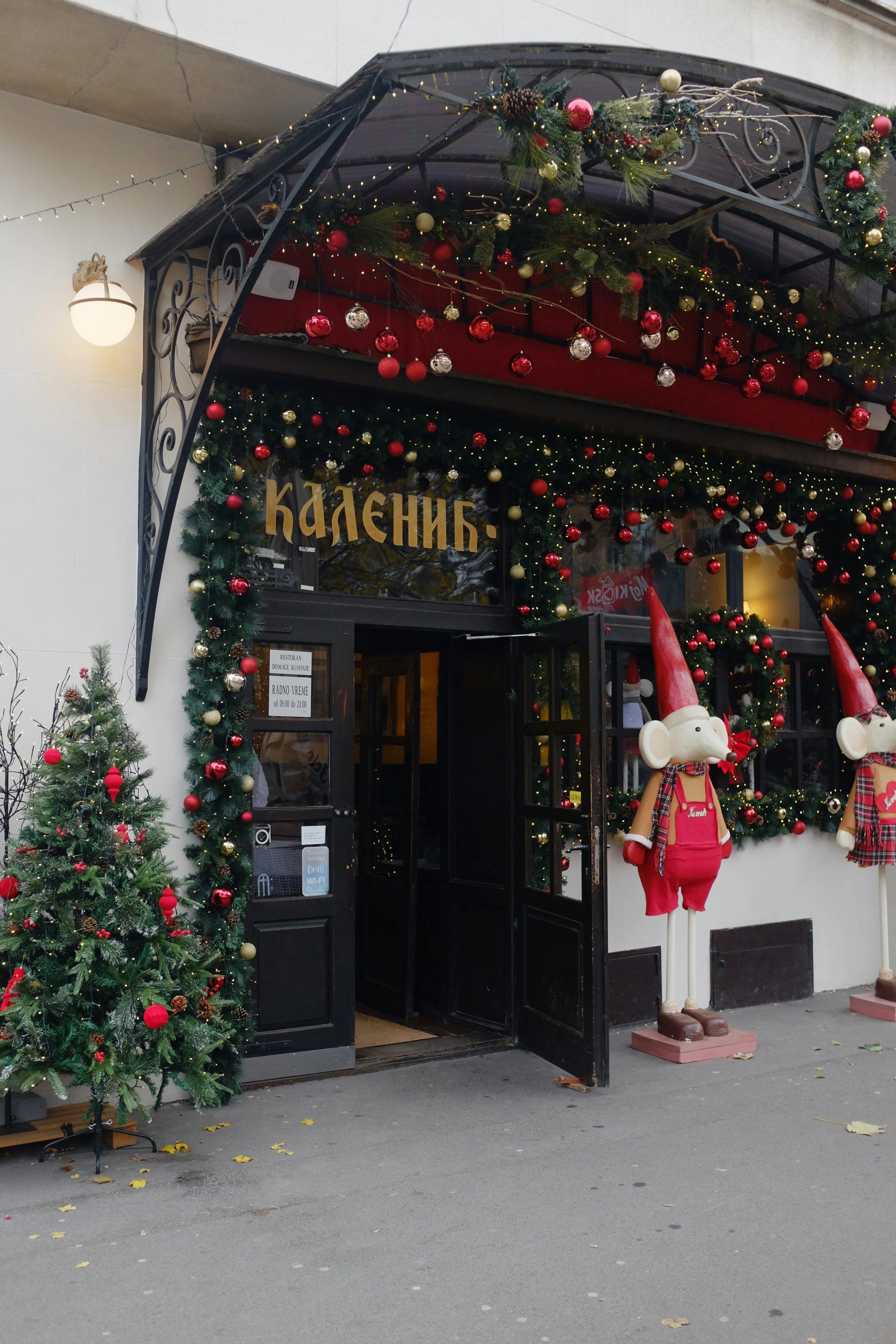 A couple of people that are standing in front of a building