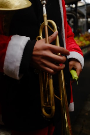 A person in a santa suit holding a trumpet