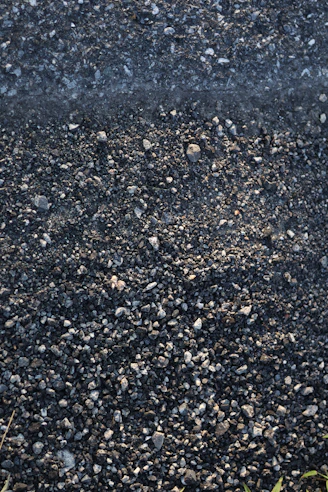 A red fire hydrant spewing water on a street