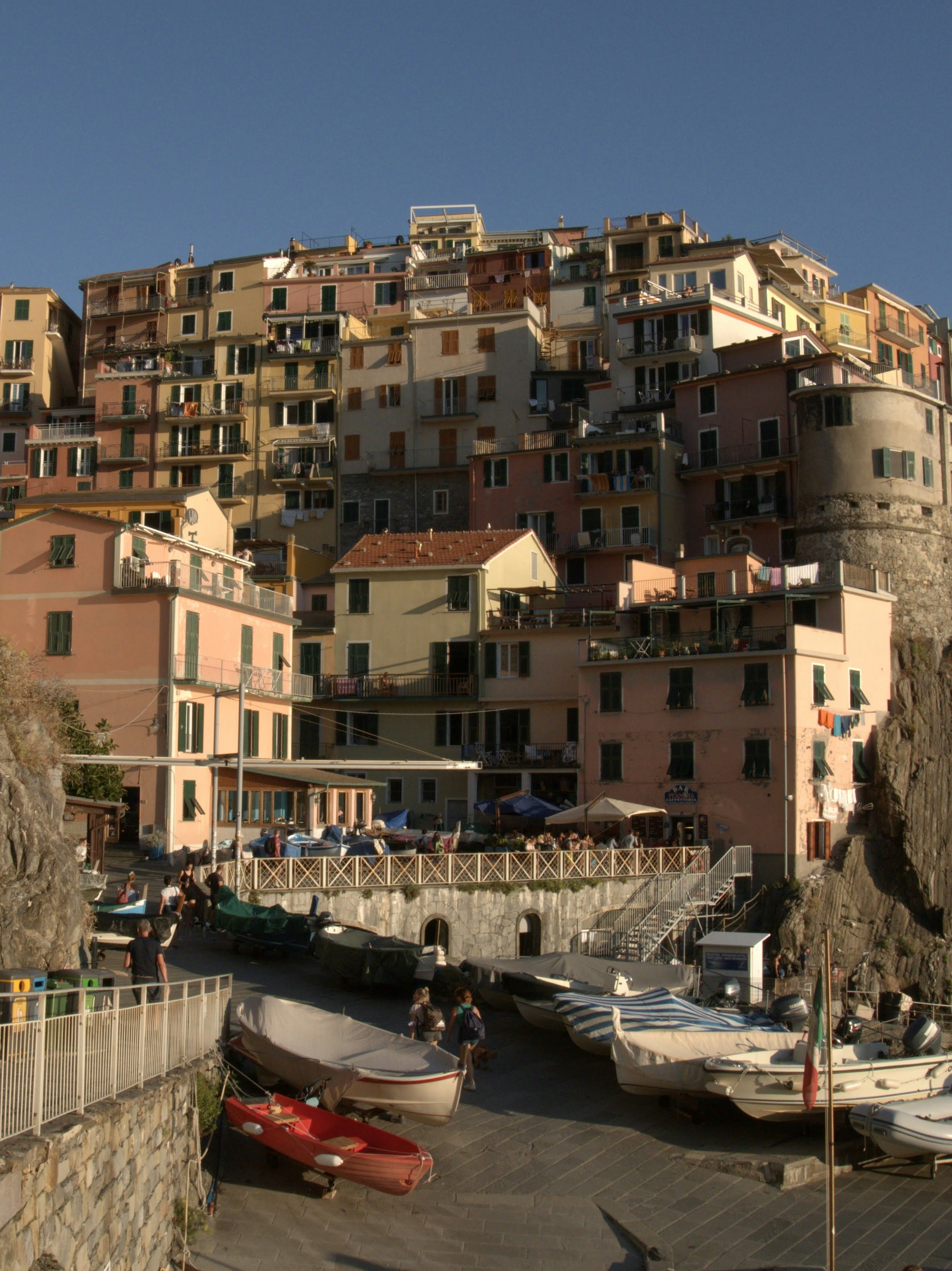 A group of boats parked in a harbor next to a city
