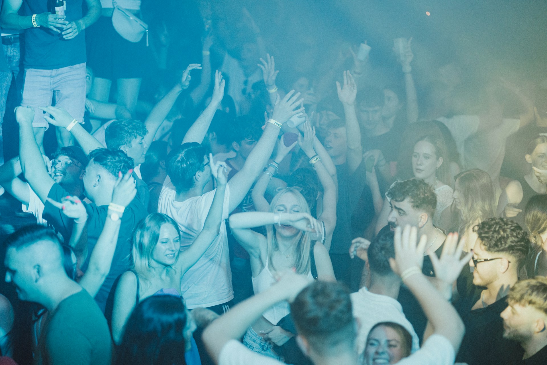 A crowd of people standing around each other