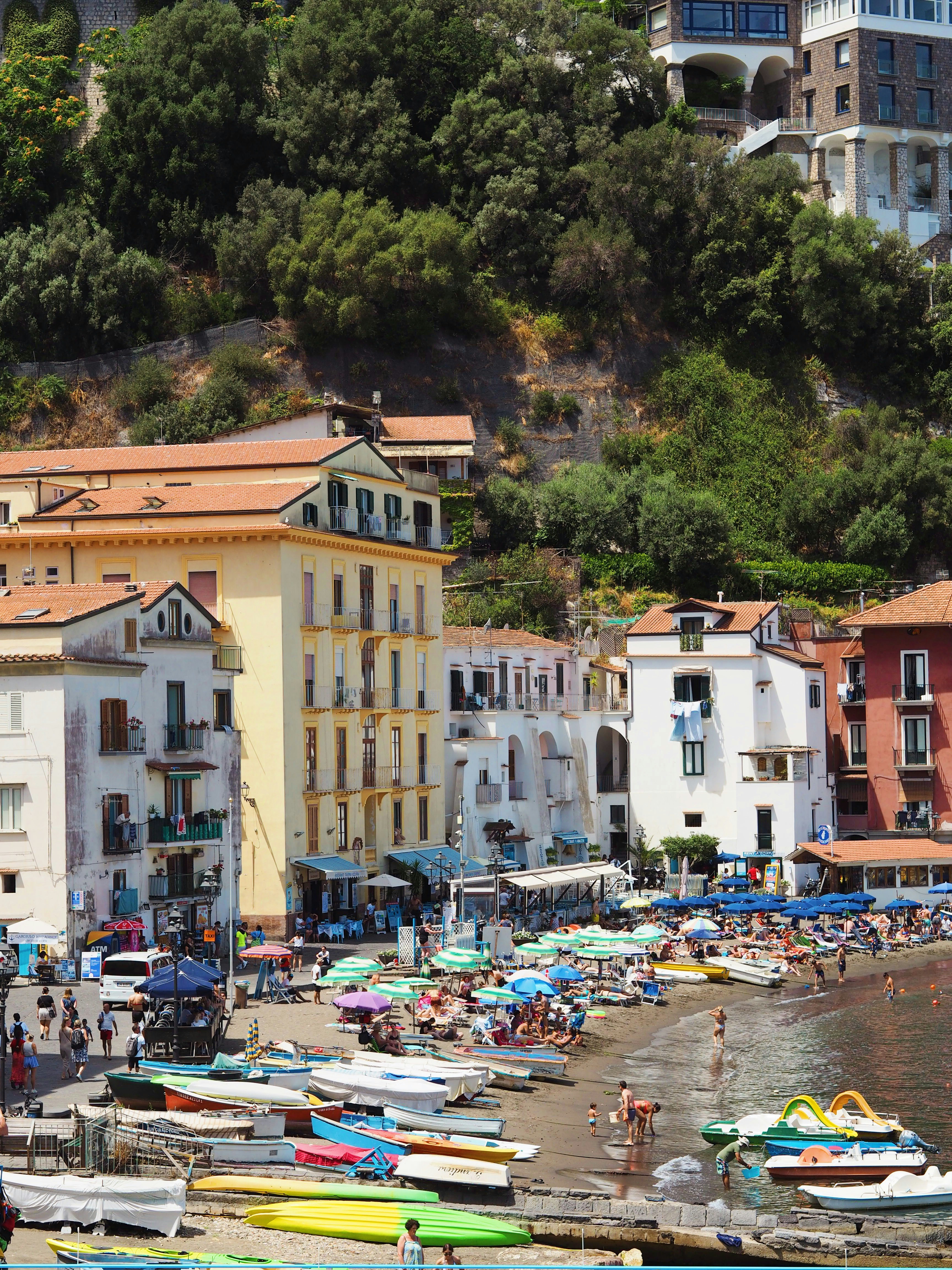Amalfi Coast - The pastel-stacked cliffs of Positano overlooking the deep blue Tyrrhenian Sea under a bright August sun.