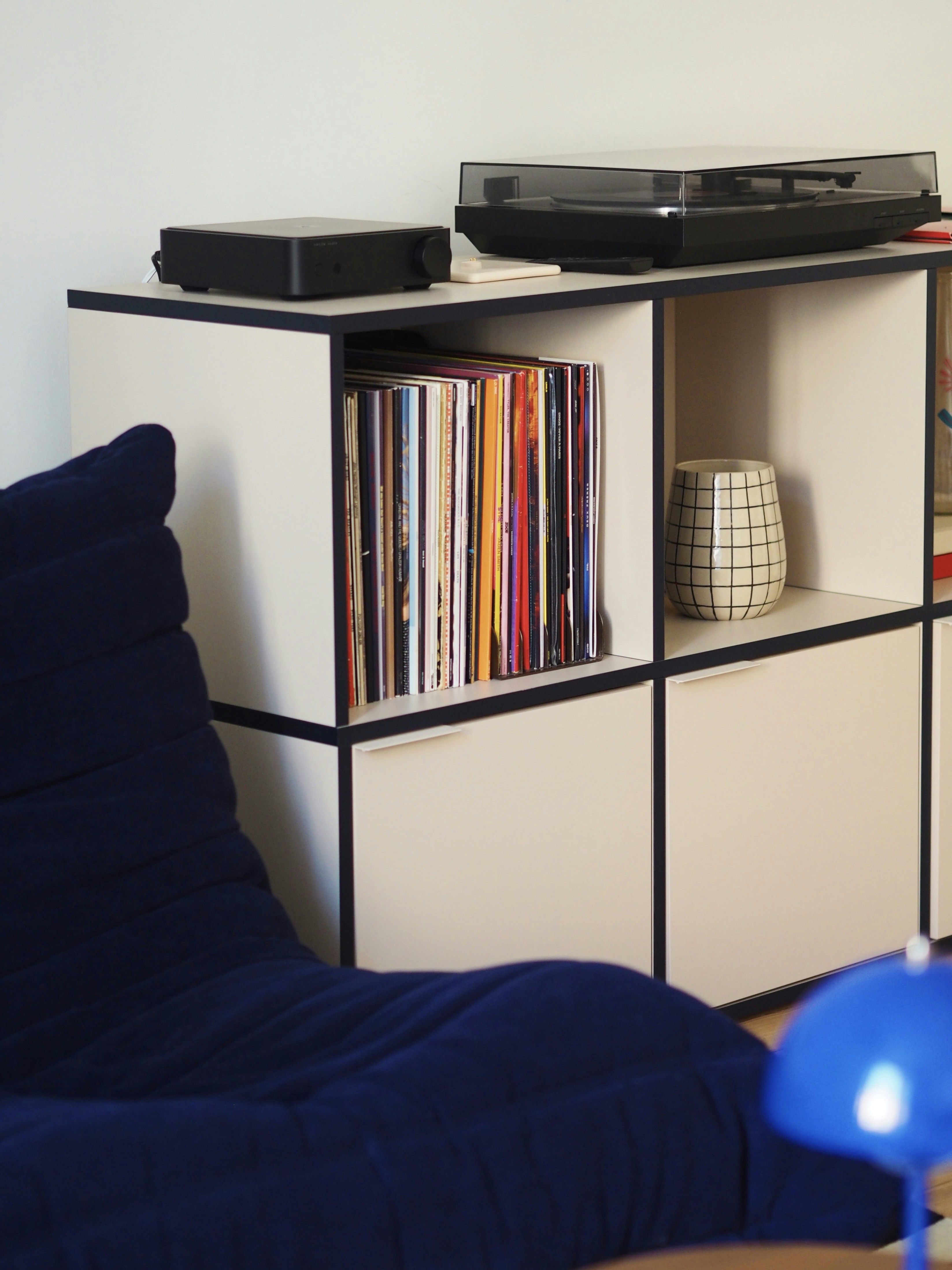 A living room with a couch and a television on a shelf