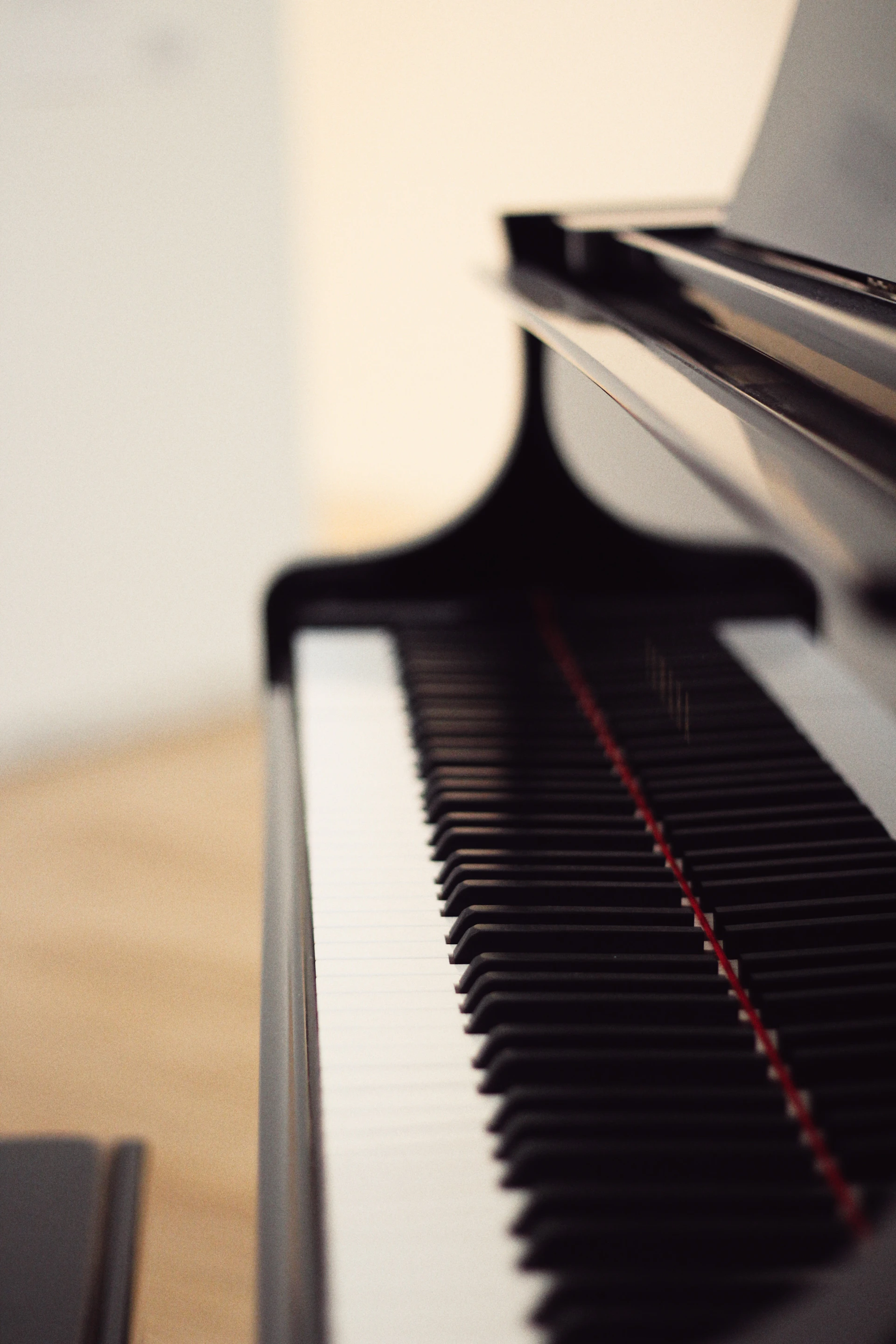 A black piano sitting on top of a wooden table