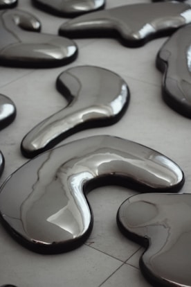 A group of shiny objects sitting on top of a tiled floor