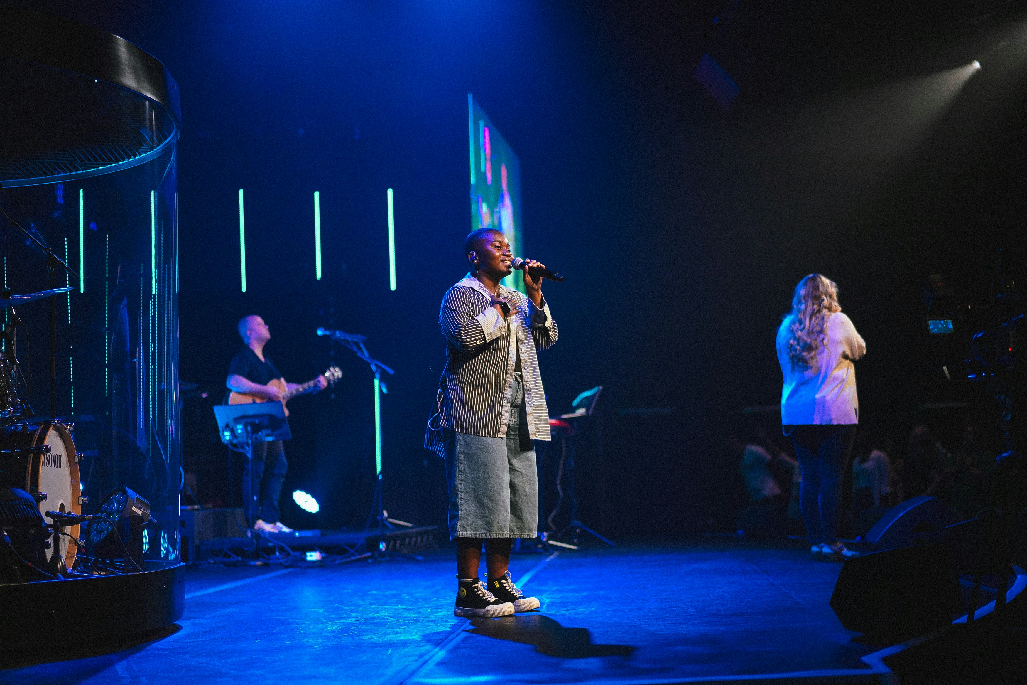 A man standing on a stage with a microphone