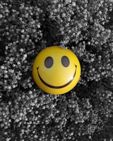 A yellow smiley face on a black and white background