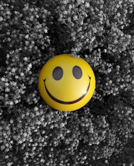 A yellow smiley face on a black and white background