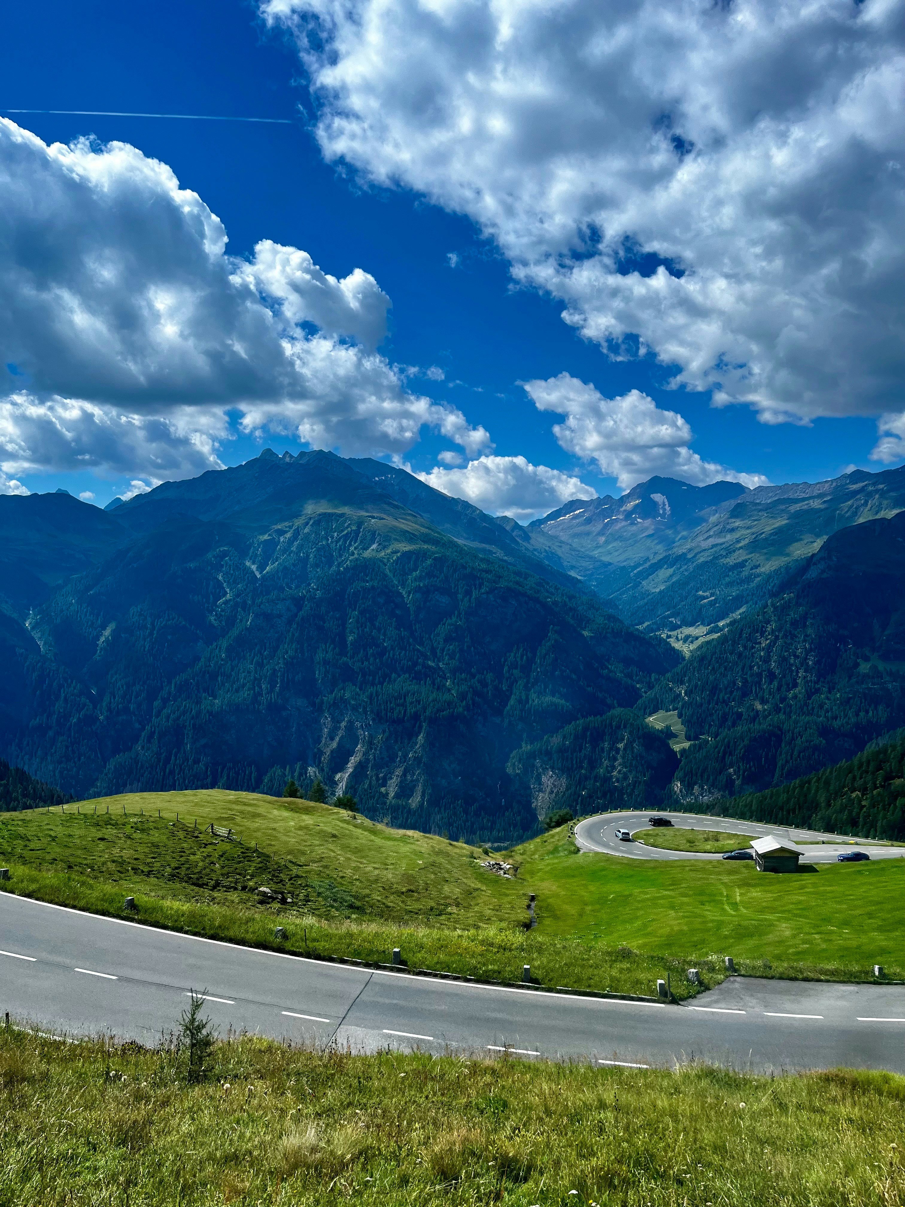 A winding road in the mountains under a cloudy sky