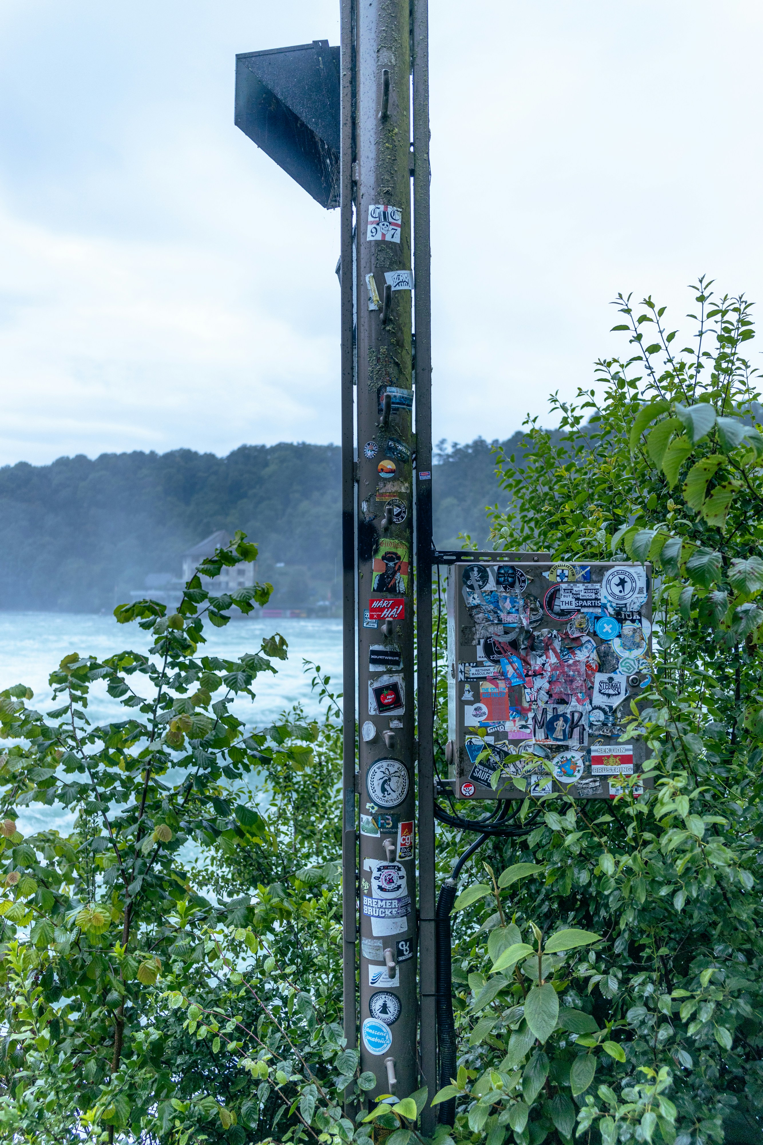 A pole with a bunch of stickers on it