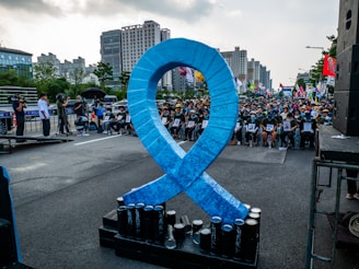 A large blue ribbon is on display in the middle of a street