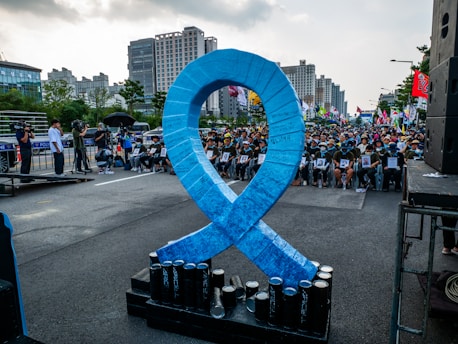 A large blue ribbon is on display in the middle of a street