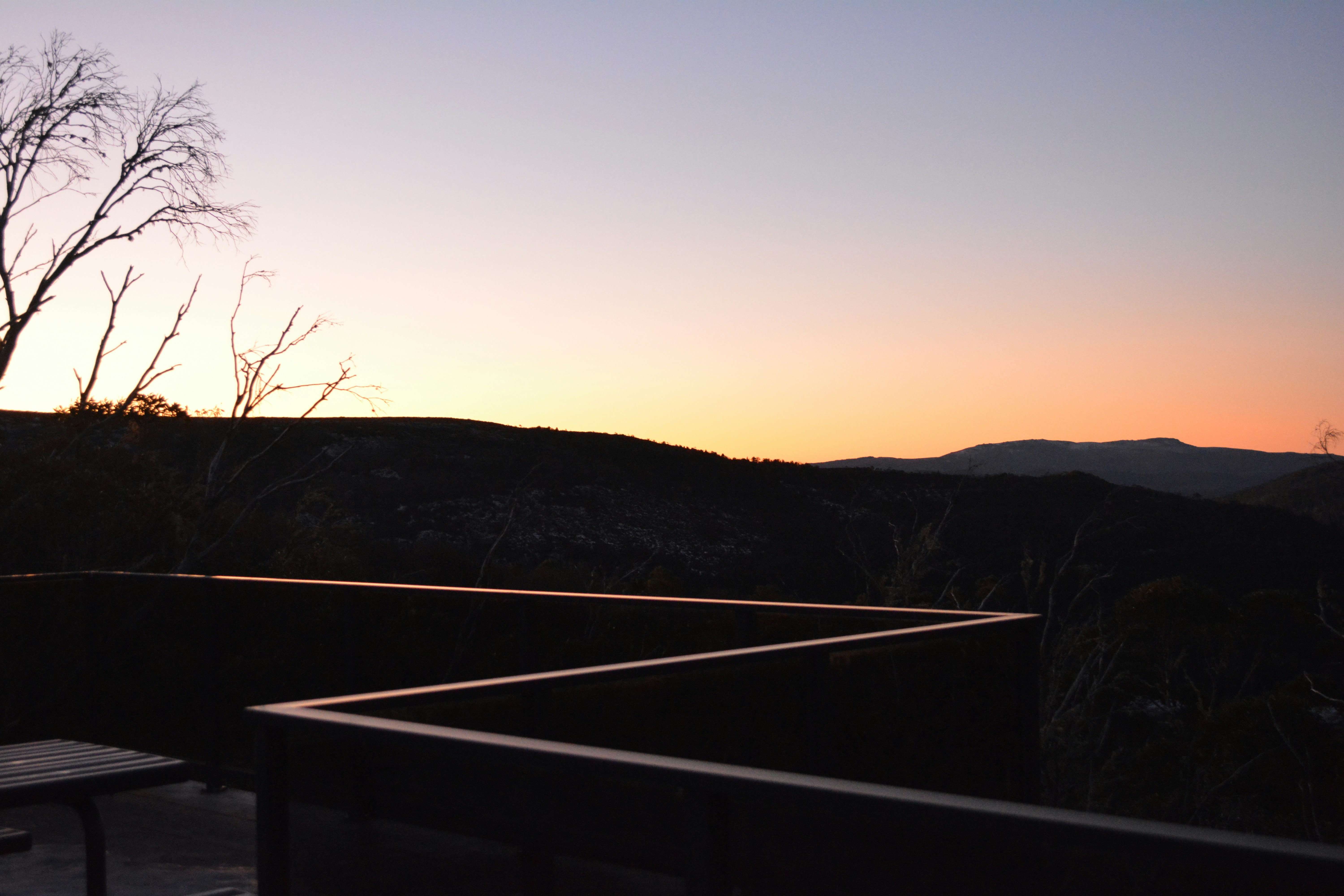A bench sitting on top of a wooden deck