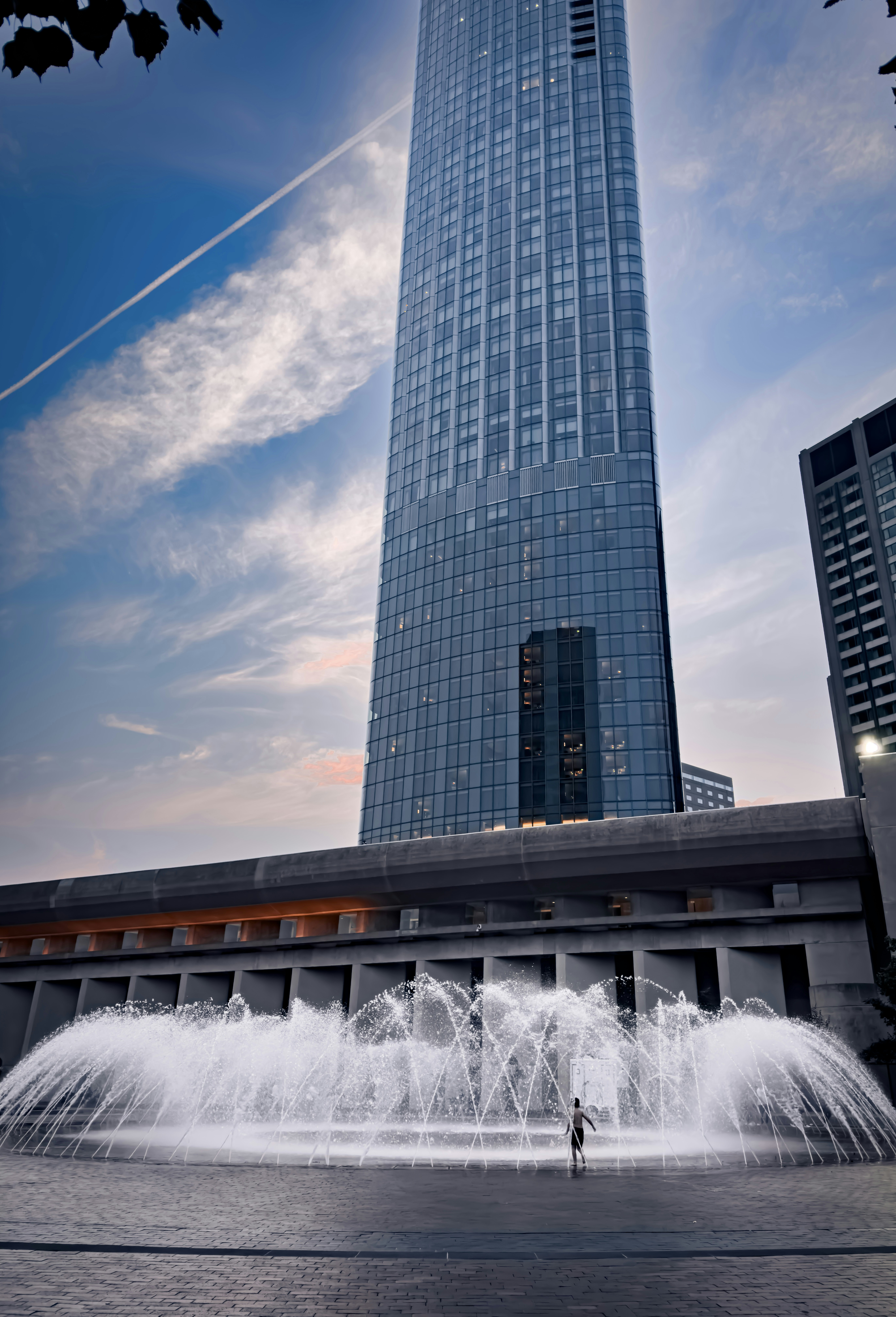 A tall building with a fountain in front of it