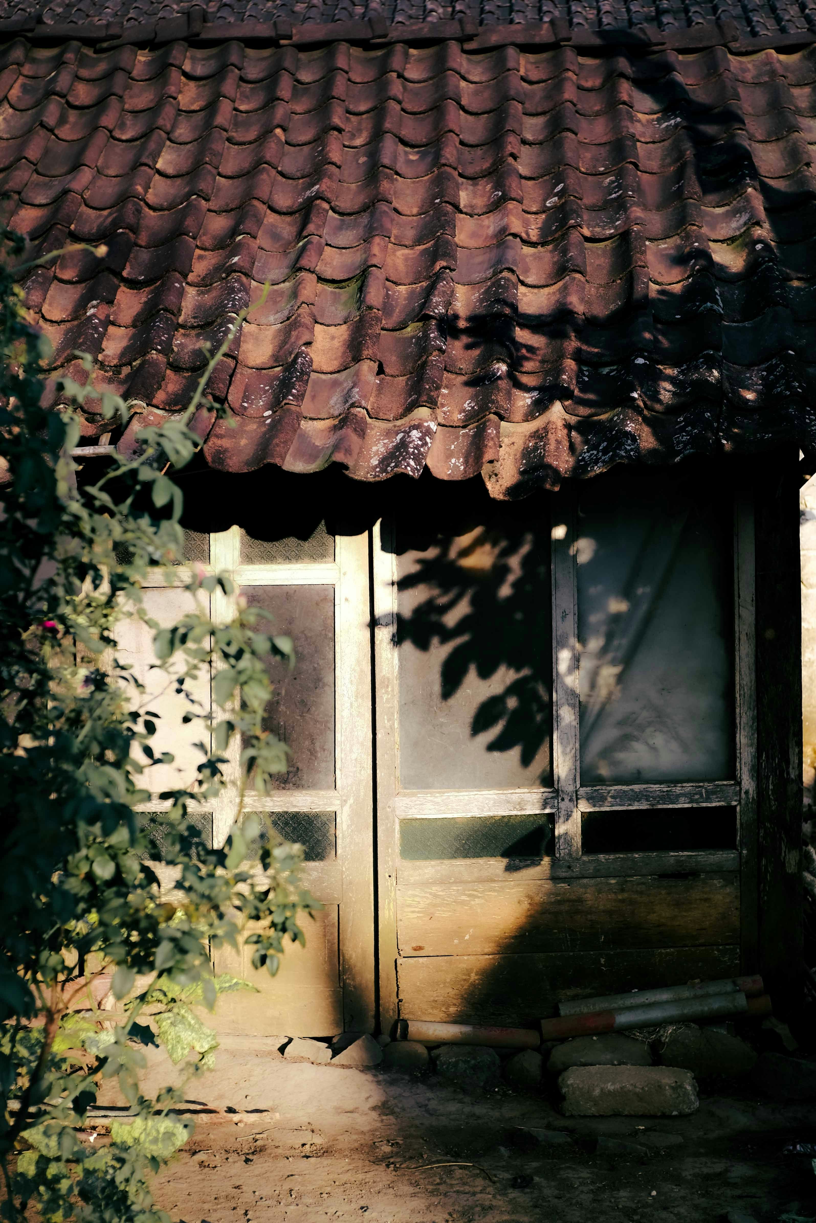 A small building with a red roof and a window