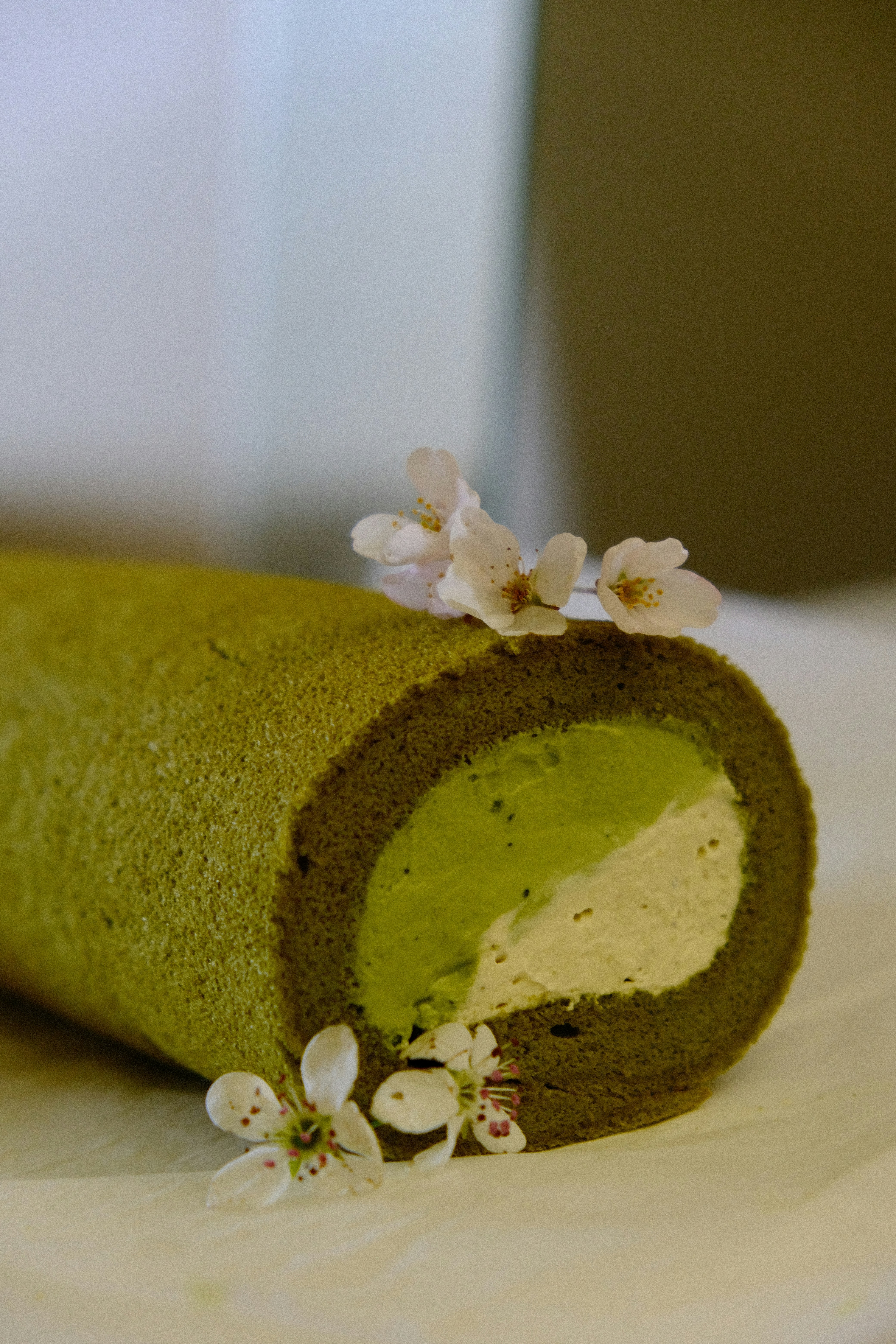 Wedding cake slice showing cherry blossom sponge with matcha cream layers
