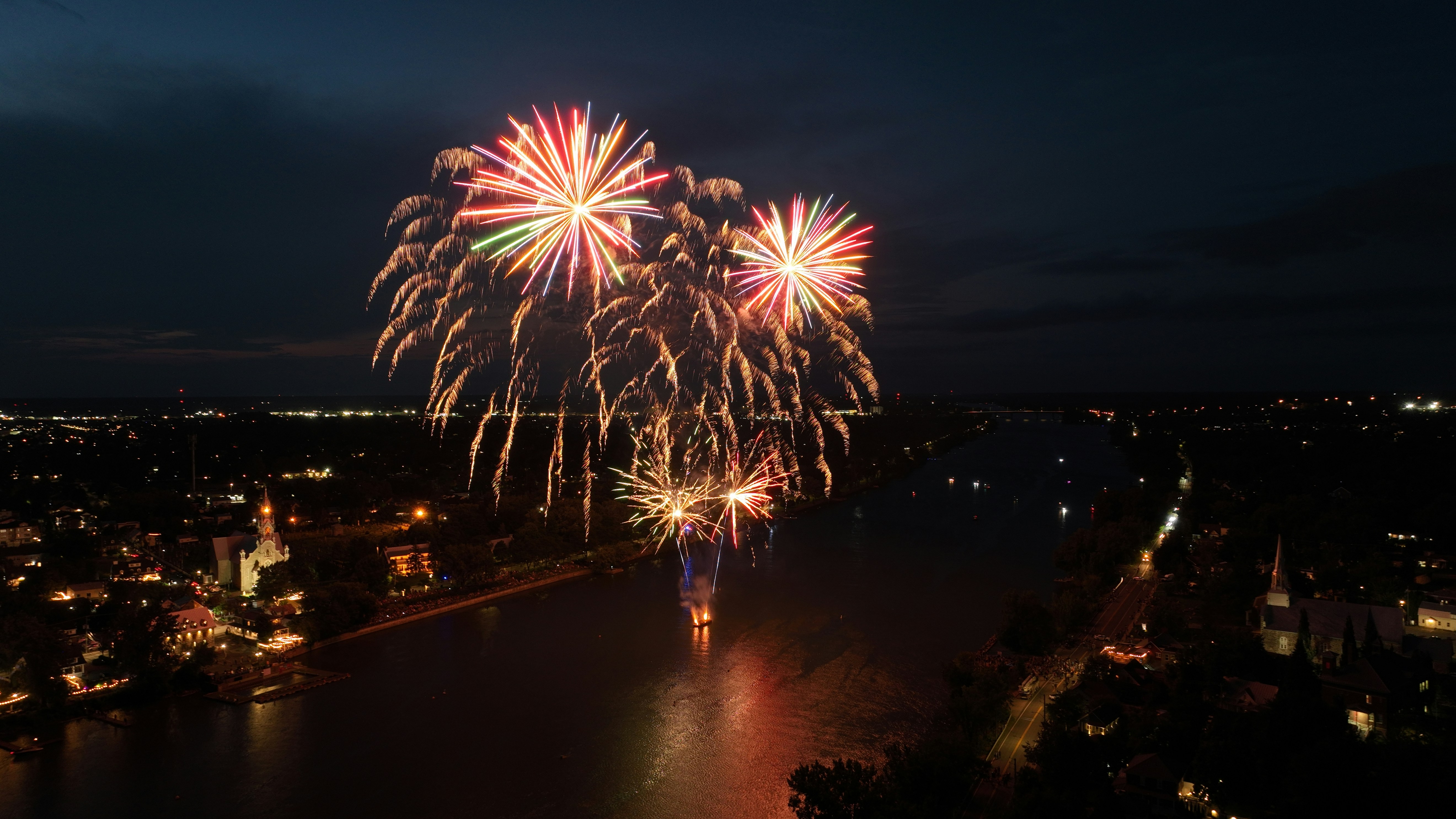 A fireworks display over a city at night