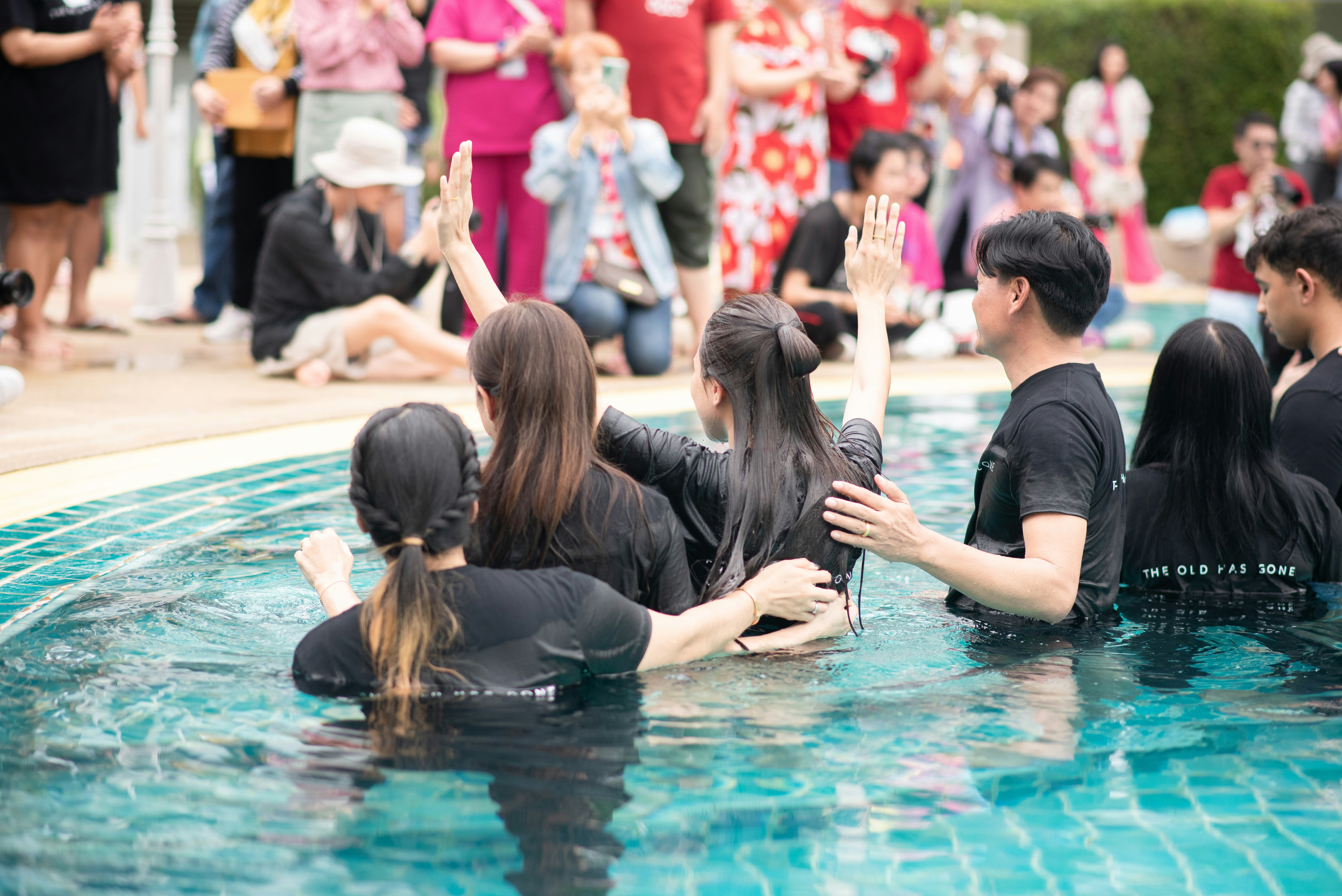 A group of people sitting in a swimming pool