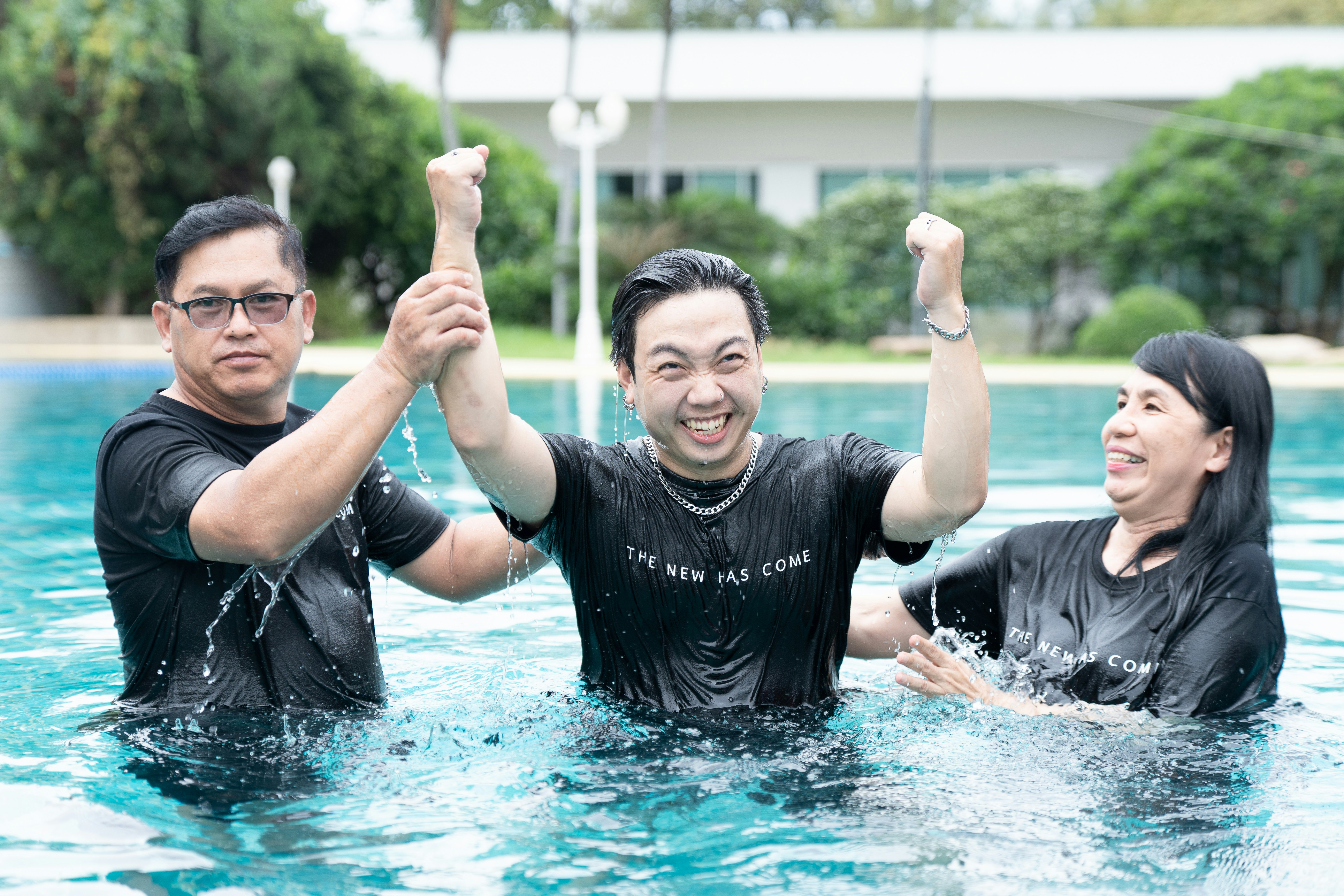 A group of people standing in a swimming pool